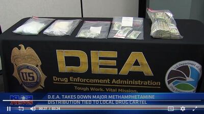 Law enforcement officials displayed some of the rugs and cash recovered in the bust.