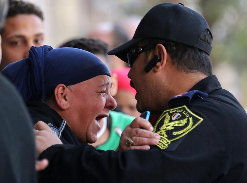 A relative of one of the blast victims screams at a police officer in front of St Mark’s Cathedral after an explosion inside the Coptic Orthodox church in Cairo. Mohamed Abd El Ghany / Reuters