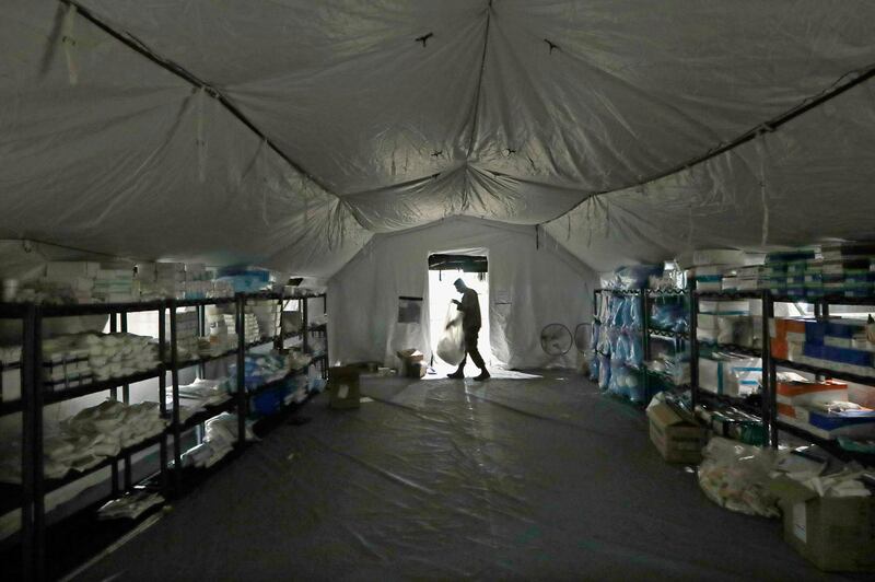 A U.S. Army soldier walks inside a mobile surgical unit being set up by soldiers from Fort Carson, Col., and Joint Base Lewis-McChord (JBLM) as part of a field hospital inside CenturyLink Field Event Center in Seattle. AP