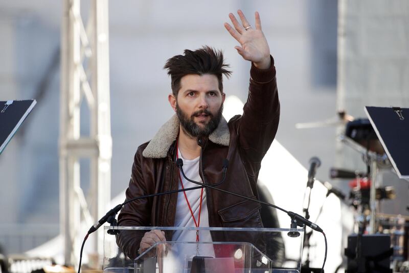 Actor Adam Scott waves toward the crowd before introducing a speaker at a Women's March in Los Angeles. Jae C Hon/ AP photo