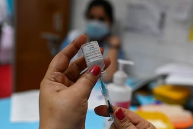 A medical worker prepares to administer a Covid-19 vaccine at a health centre in New Delhi, India. AFP