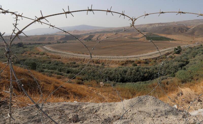 FILE - In this Nov. 13, 2019, file photo, a portion of the Israeli-Jordanian border â€‹â€‹is viewed through a barbed wire fence from Baqoura, in the Jordan Valley. Jordanâ€™s Foreign Ministry on Thursday, April 30, 2020 announced that Israeli farmers will no longer be allowed to work their fields in an enclave of southern Jordan, ending a more than 25-year arrangement meant to shore up a historic peace agreement. (AP Photo/Raad Adayleh, File)