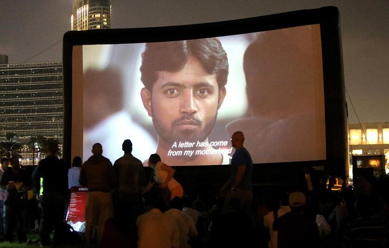 Dubai residents watch the screening of the film Camp Ka Champ at the Burj Park last week. Satish Kumar / The National 