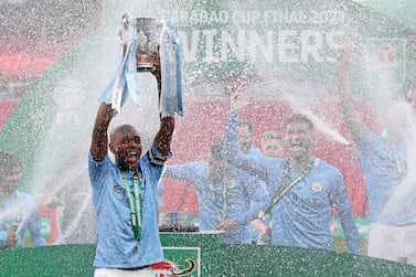 TOPSHOT - Manchester City's Brazilian midfielder Fernandinho lifts the winners trophy after the English League Cup final football match between Manchester City and Tottenham Hotspur at Wembley Stadium, northwest London on April 25, 2021. Manchester City claimed a fourth consecutive League Cup on Sunday with a dominant display to beat Tottenham 1-0 in front of 8,000 fans at Wembley. - RESTRICTED TO EDITORIAL USE. No use with unauthorized audio, video, data, fixture lists, club/league logos or 'live' services. Online in-match use limited to 120 images. An additional 40 images may be used in extra time. No video emulation. Social media in-match use limited to 120 images. An additional 40 images may be used in extra time. No use in betting publications, games or single club/league/player publications. / AFP / POOL / CARL RECINE / RESTRICTED TO EDITORIAL USE. No use with unauthorized audio, video, data, fixture lists, club/league logos or 'live' services. Online in-match use limited to 120 images. An additional 40 images may be used in extra time. No video emulation. Social media in-match use limited to 120 images. An additional 40 images may be used in extra time. No use in betting publications, games or single club/league/player publications.