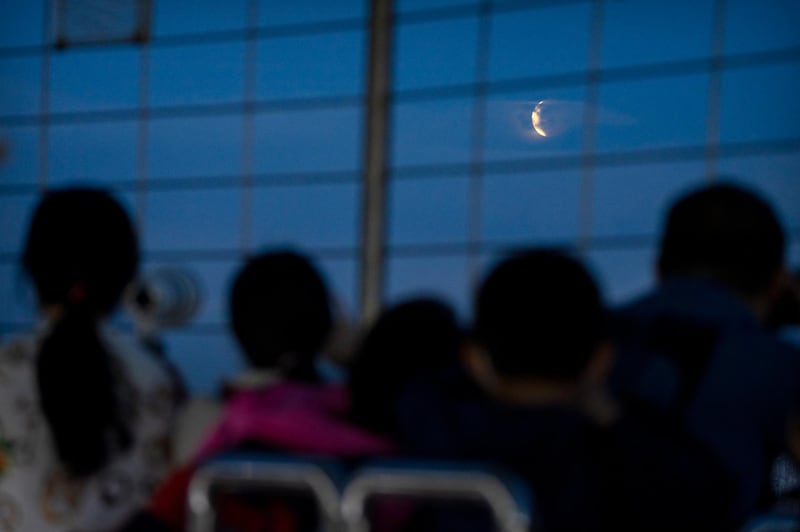 People watch the eclipse from the Central Radio and TV Tower in Beijing, China. It was the first total lunar eclipse in more than two years. AP