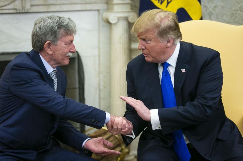 U.S. President Donald Trump, right, shakes hands with Danny Burch, a former U.S. hostage in Yemen, during a meeting in the Oval Office of the White House in Washington, D.C., U.S., on Wednesday, March 6, 2019. Trump welcomed Burch home after he was held by Yemeni rebels for a year and a half. Photographer: Al Drago/Bloomberg