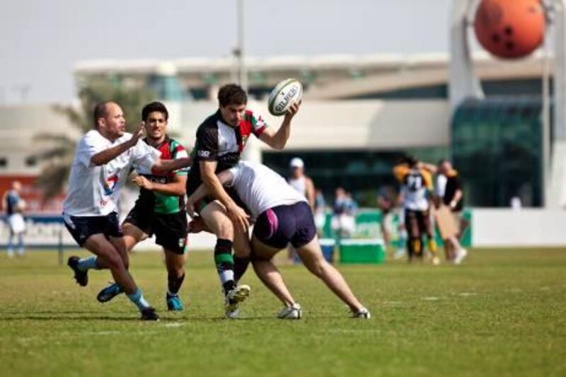 Abu Dhabi Harlequins  Pat Hegarty (at right) runs with the ball during the AD Quins' game with the Frogs on Friday, Nov. 25, 2011 at the Zayed Sports City rugby pitches in Abu Dhabi. AD Quins won the tournament. (Silvia Razgova/The National)
