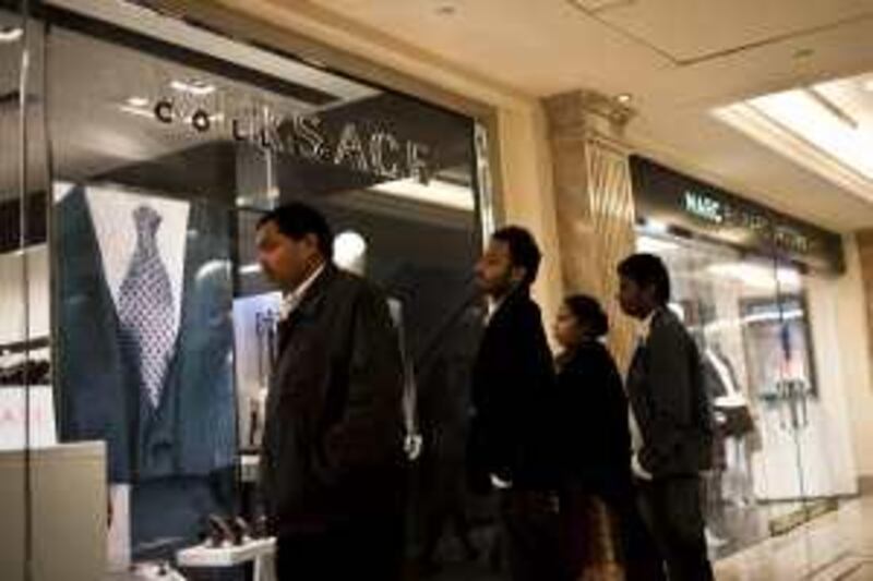 An Indian family is seen checking the show window of a luxury brand store in Emporio Mall in New Delhi, India. Emporio is India's only Luxury mall with the world's top designer brands. Photo: Sanjit Das for The National *** Local Caption ***  sdas17012010_luxury-mall_delhi-041.jpg