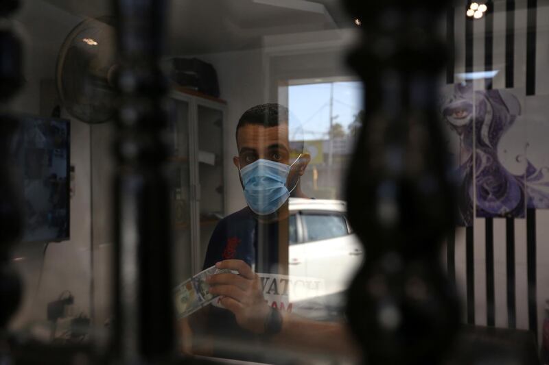 A currency exchange office worker counts US dollars banknotes at a money exchange office, in central Baghdad, Iraq. EPA