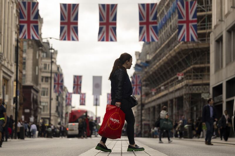 A shopper cross Oxford Street in London. Retail sales have fallen short of expectations. Bloomberg