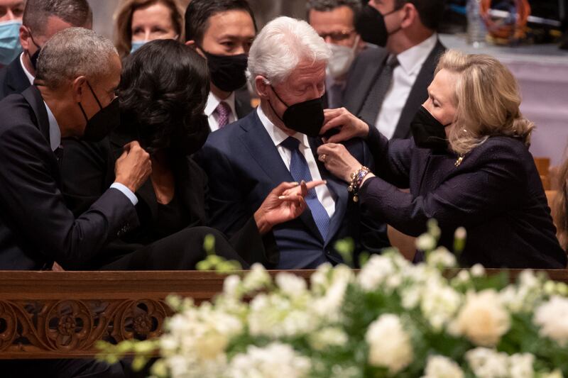 Barack and Michelle Obama chat to Bill and Hillary Clinton. EPA