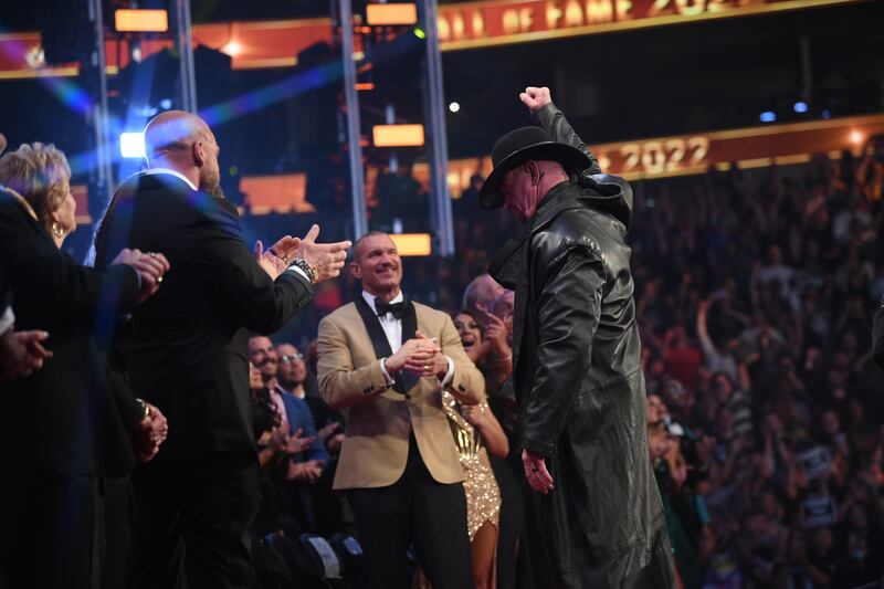 The Undertaker salutes the fans as he walks off stage.