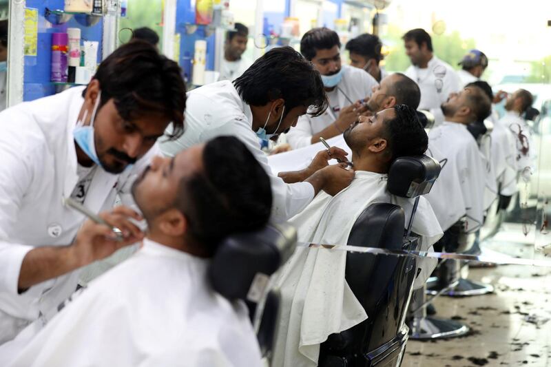 Abu Dhabi, United Arab Emirates - June 03, 2019: Gentlemen get a trim as people prepare for Eid. Monday the 3rd of June 2019. Bani Yas, Abu Dhabi. Chris Whiteoak / The National