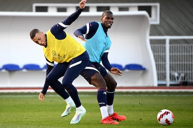 France's forward Kylian Mbappe (L) fights for the ball with France's mdfielder Paul Pogba during a training session in Clairefontaine-en-Yvelines near Paris on March 22, 2022 ahead of the friendly football matches against Ivory Coast and South Africa.  (Photo by FRANCK FIFE  /  AFP)