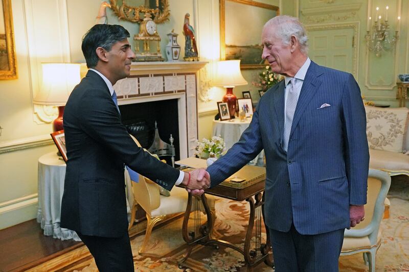 King Charles III, right, and Britain's Prime Minister Rishi Sunak shake hands during their meeting at Buckingham Palace, London. AP