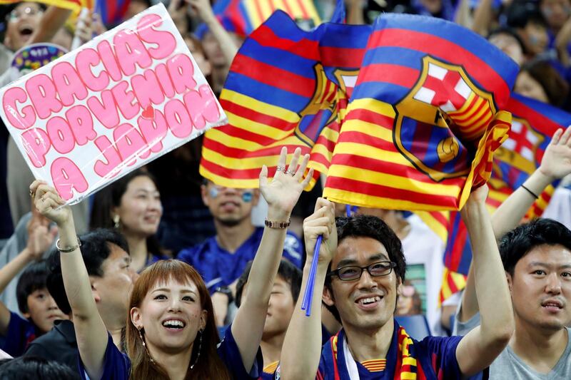 Fans cheers for Barcelona at the Saitama Stadium. Reuters