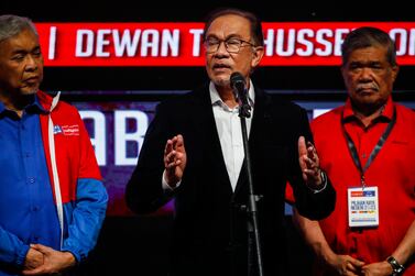 Malaysia's Prime Minister Anwar Ibrahim (C) speaks as his deputy Ahmad Zahid Hamidi (L) looks on during press conference after state election result at the World Trade Centre Kuala Lumpur, Malaysia, 12 August 2023.  Voting in the six states including Selangor, Kelantan, Penang, Kedah, Negeri Sembilan and Terengganu were held, with a total of 570 candidates vying for the 245 contested state seats.   EPA / FAZRY ISMAIL