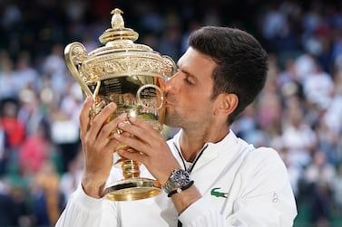 Novak Djokovic kisses the  trophy after defeating Roger Federer in the men's final at Wimbledon in 2019. There will be no tournament in 2020. EPA