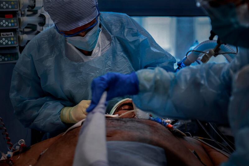 Healthcare workers attend to a coronavirus patient at the Intensive Care Unit of Sao Joao Hospital in Porto. AFP