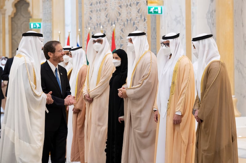 Isaac Herzog greets Mohamed Al Khaja, UAE Ambassador to Israel (L). Seen with Mohamed Al Mubarak, Khaldoon Al Mubarak, Sarah Al Amiri and other dignitaries. Mohamed Al Hammadi / Ministry of Presidential Affairs
