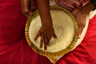 A child performs a ritual as he writes alphabets with his forefinger on a plate of rice during which children are initiated to the world of education as part of the Akshara Bhyasam or Vidyarabham ceremony on the auspicious day of Vijayadashami or Dussehra during Navratri festival near Ayyappan temple, in Chennai, India, 15 October 2021.  Akshara Bhyasam or Vidyarabham is a Hindu traditional ceremony observed on the auspicious day of Vijayadashami during the Navratri festival in the states of Andhra Pradesh, Kerala, Tamil Nadu, and Karnataka.  Akshara means letters or alphabets and Abhyasam means practice, so that is the study of practical letters.  The ritual involves Goddess Saraswati Puja, in which Hindu families help their children to learn and write alphabets so that the child is ready to receive formal education.   EPA / IDREES MOHAMMED