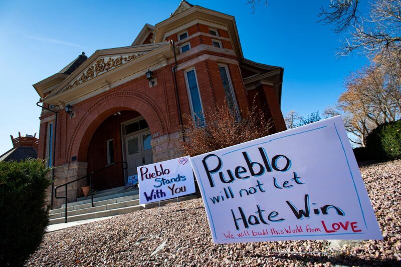 FILE - In this July 25, 2020, file photo, signs, flowers and candles expressing love for the Jewish community stand outside the Temple Emanuel in Pueblo, Colo. Richard Holzer, 28, a man described by federal prosecutors as a neo-Nazi and white supremacist, pleaded guilty Thursday, Oct. 15, 2020, to a hate crime for plotting to bomb the historic Colorado synagogue last year. (Christian Murdock/The Gazette via AP, File)