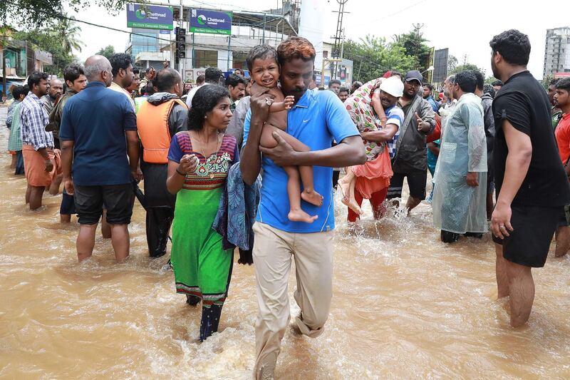 Volunteers and rescue personal evacuate local residents in Ernakulam district. AFP