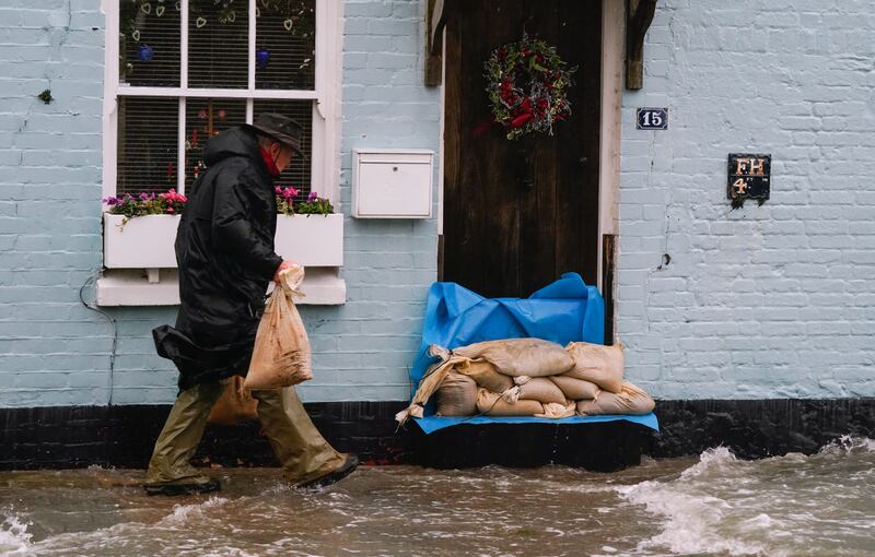 Sand bags are placed outside a property in Langstone, Hampshire. PA