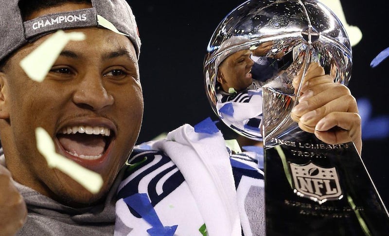 Seattle Seahawks linebacker Malcolm Smith holds the Vince Lombardi Trophy after defeating the Denver Broncos in Super Bowl XLVIII. Smith was named MVP. Paul Buck / EPA