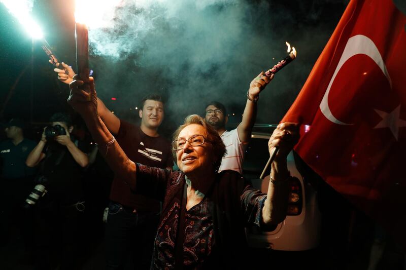 Supporters of Ekrem Imamoglu, the candidate of the secular opposition Republican People's Party, CHP, light up a flare as they celebrate in central Istanbul, Sunday, June 23, 2019. In a blow to Turkish President Recep Tayyip Erdogan, Imamoglu declared victory in the Istanbul mayor's race for a second time Sunday after Binali Yildirim, the government-backed candidate conceded defeat in a high-stakes repeat election. (AP Photo/Lefteris Pitarakis)