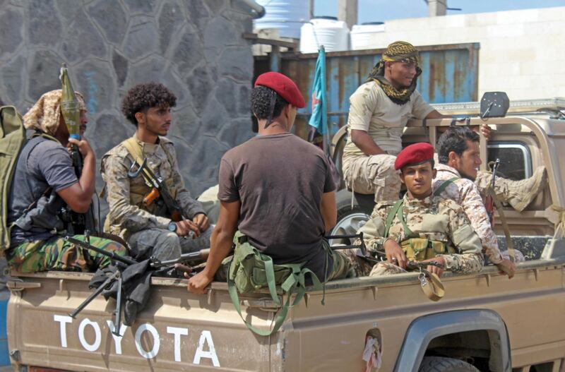 Yemeni military security personnel sit in the back of a pick up truck at the airport in the southern city of Aden on January 3, 2021, as activity resumes after explosions rocked the building on December 30, killing or injuring dozens of people. The deadly blasts targeted cabinet members of Yemen's new government, killing at least 26 people, including three members of the International Committee of the Red Cross and a journalist. / AFP / Saleh OBAIDI
