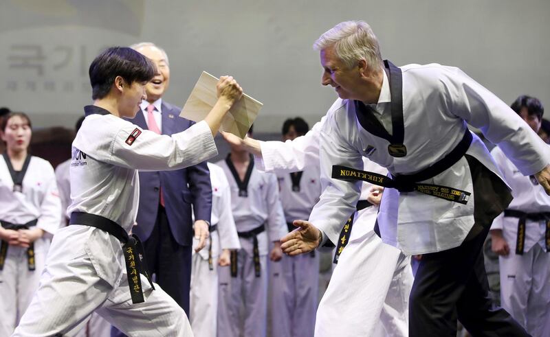 Belgium's King Philippe breaks a wooden plate during a demonstration of Taekwondo in Seoul, South Korea. AP Photo