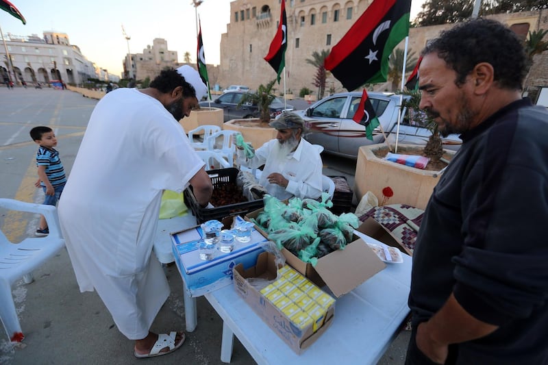 Libyans prepare to distribute snacks and water to people to break their fast near sunset during the Muslim holy month of Ramadan in the Martyrs Square of the capital Tripoli, on May 15, 2019.
  / AFP / Mahmud TURKIA
