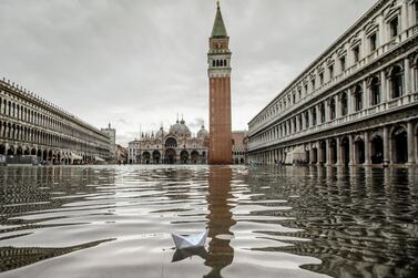 This photo from November this year shows a paper boat floating in a flooded St. Mark's Square in Venice. AP / Luca Bruno