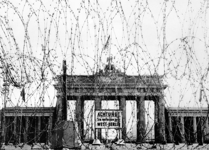 BERLIN - NOVEMBER 1961:  (FILE PHOTO)  Saturday, August 13th will celebrate 50 Years Since East German Troops Sealed The Border Between East And West Berlin
Please refer to the following profile on Getty Images Archival for further imagery. 
http://www.gettyimages.co.uk/EditorialImages/News?parentEventId=120436353
and
http://www.gettyimages.co.uk/Search/Search.aspx?EventId=120437101&EditorialProduct=Archival
And Also
In Profile: The Berlin Wall 
http://www.gettyimages.co.uk/Search/Search.aspx?EventId=120436548&EditorialProduct=Archival

Barbed wire on the West side of the Brandenburg gate, put up as a 'Safety measure' by the British in 1961 in Berlin, Germany.  (Photo by Keystone/Getty Images) *** Local Caption ***  3304302.jpg