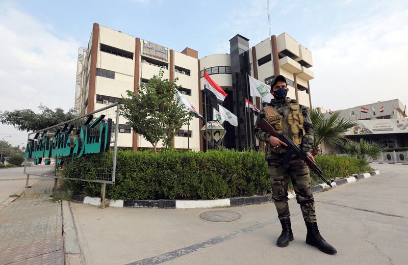 A Peace Brigades fighter on guard outside the hospital