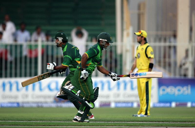SHARJAH , UNITED ARAB EMIRATES Ð Aug 28 : Nasir Jamshed ( left ) and Muhammad Hafeez ( right ) of Pakistan running between the wicket during the 1st one day international cricket match between Pakistan vs Australia at Sharjah Cricket Stadium in Sharjah. ( Pawan Singh / The National ) For  Sports. Story Paul and Ahmed