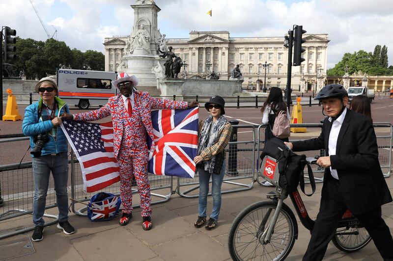 Royal fan Joseph Afrana holds flags with tourists from Taiwan near Buckingham Palace during U.S. President Donald Trump’s state visit to Britain in London, Britain, June 3, 2019. Reuters