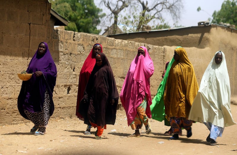 Women walk along a street of Dapchi village, Yobe State, Nigeria February 24, 2018. REUTERS/Afolabi Sotunde