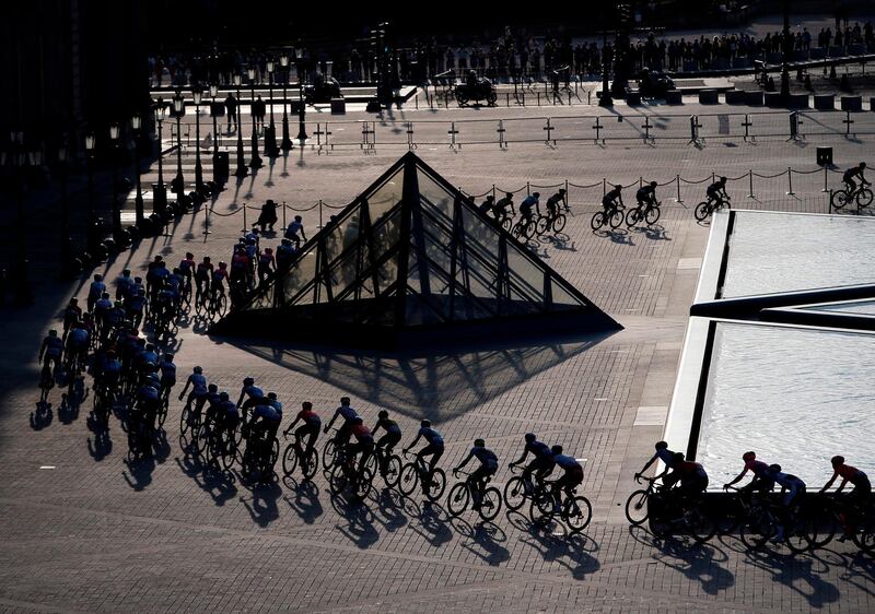 The peloton rides through the courtyard of the Louvre museum on July 28, 2019.  AFP