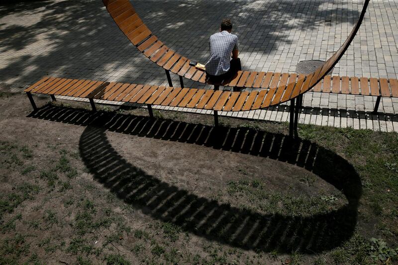 A man rests on a bench in a park in central Kiev, Ukraine July 5, 2018. REUTERS/Valentyn Ogirenko TPX IMAGES OF THE DAY