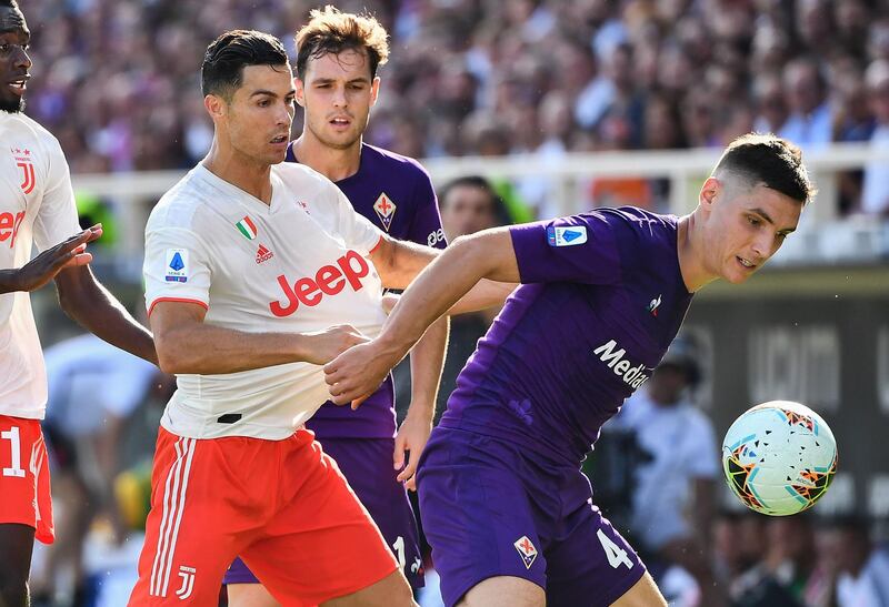 Fiorentina's Serbian defender Nikola Milenkovic holds off Juventus' Portuguese forward Cristiano Ronaldo. AFP