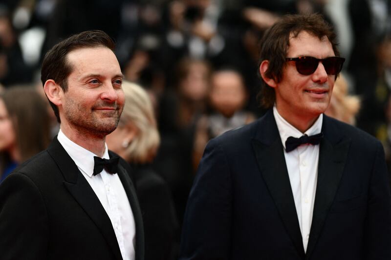 Tobey Maguire and Lukas Haas pose together on the red carpet. AFP