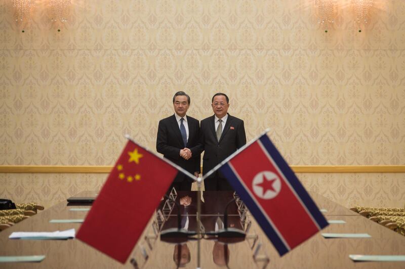 China's foreign minister Wang Yi, left, shakes hands with North Korea's foreign Minister Ri Yong Ho at the Mansudae Assembly Hall in Pyongyang. Kim Won-jin / AFP Photo