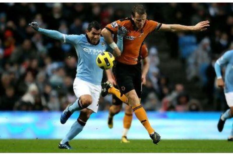 Carlos Tevez, left, tussles for the ball with Christophe Berra, the Wolves defender.