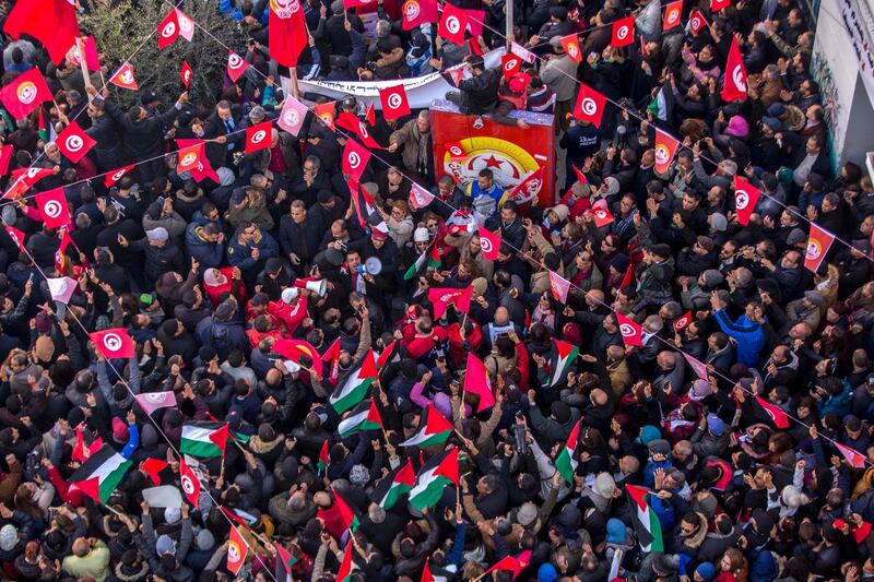 Workers gather in front of the national union headquarters. AP Photo