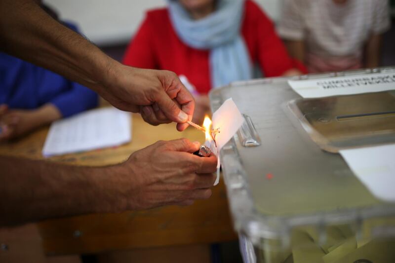 A ballot box is opened to start counting votes at a polling station in the mainly-Kurdish city of Diyarbakir, southeastern Turkey, Sunday, June 24, 2018. The polls have closed in Sunday's Turkish landmark presidential and parliamentary elections where President Recep Tayyip Erdogan is seeking re-election to a presidency with vastly expanded powers.(AP Photo/Emre Tazegul)