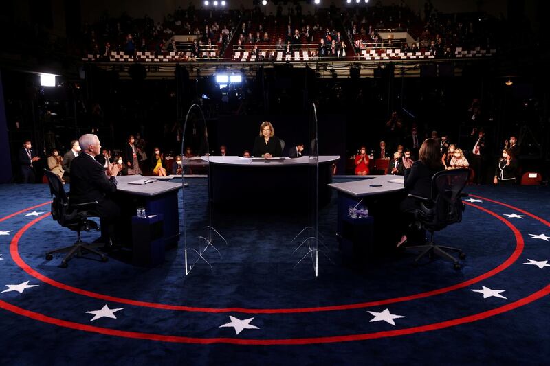 US Vice President Mike Pence and Democratic vice presidential nominee and US Senator Kamala Harris applaud at the end of the 2020 vice presidential debate moderated by Susan Page of USA Today, on the campus of the University of Utah in Salt Lake City, Utah, US. Reuters