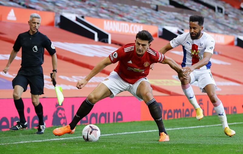 Manchester United defender Harry Maguire holds off Crystal Palace's Andros Townsend. AFP