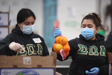 Volunteers Jailene Cruz and Genesis Maldonado sort food at the Los Angeles Regional Food Bank distribution centre, as the global outbreak of the coronavirus disease continues, in Los Angeles, California, US. Reuters